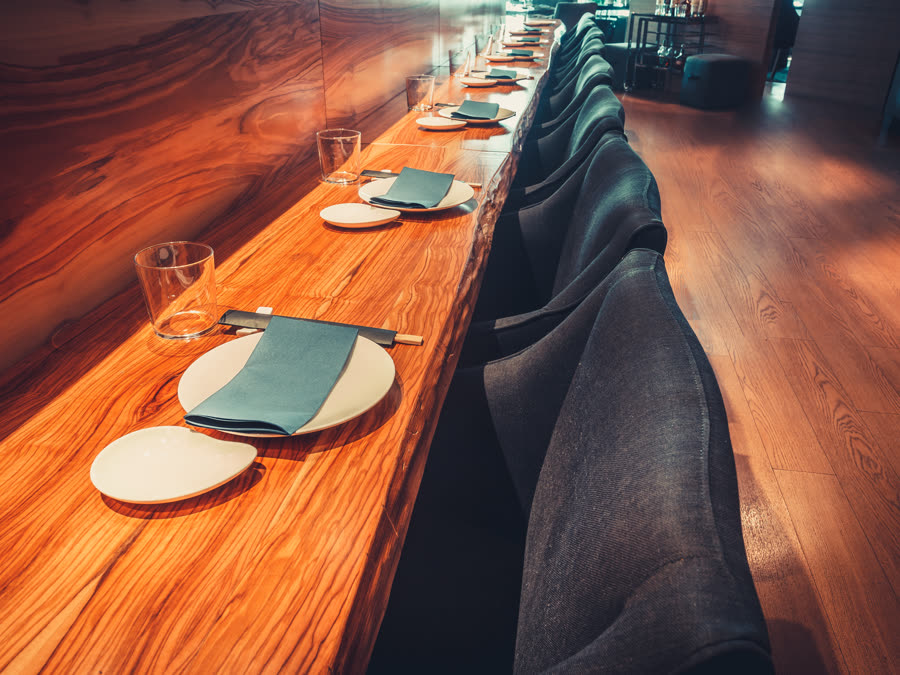 An empty seat at a restaurant counter.